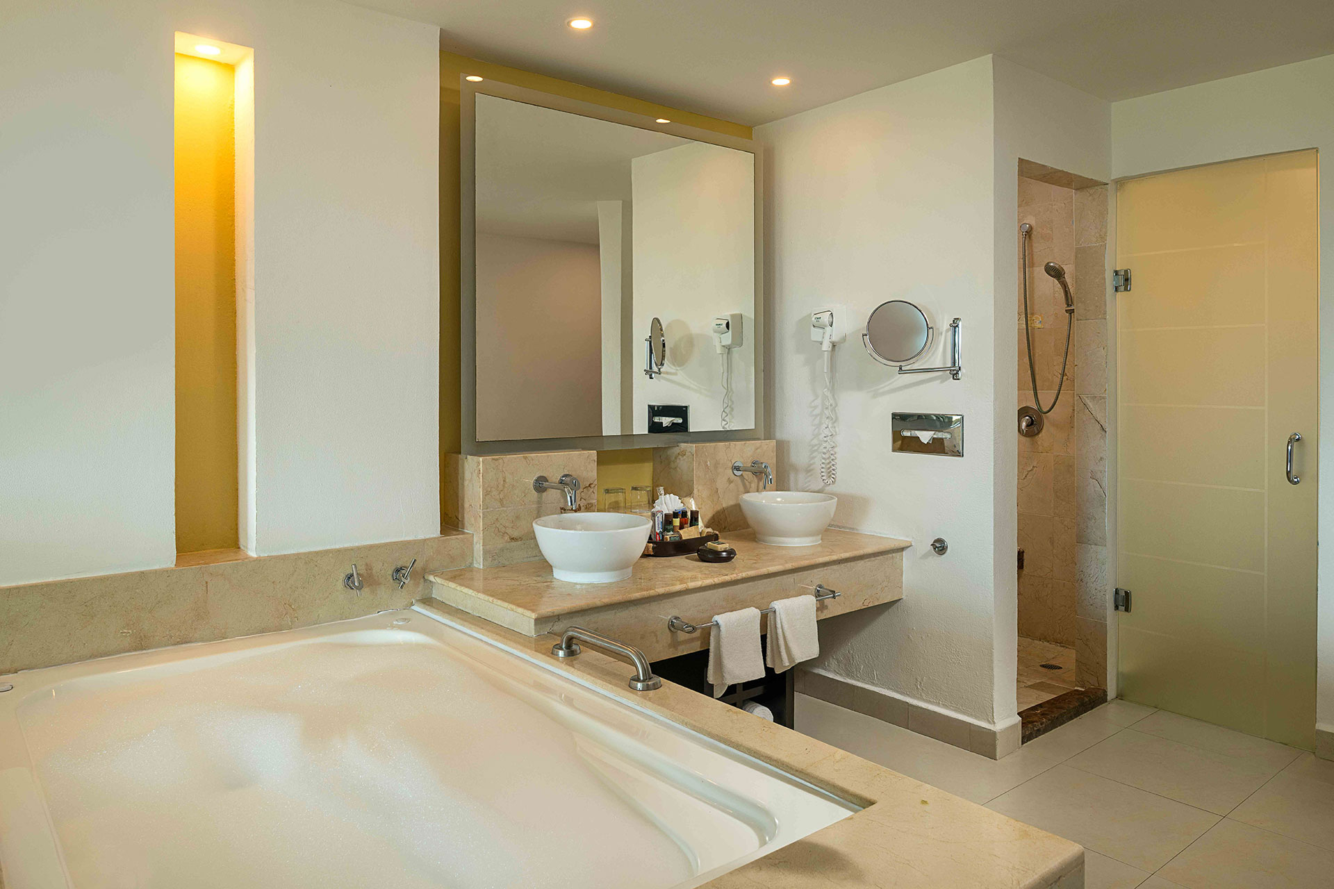 A private balcony with a a jacuzzi and seating area