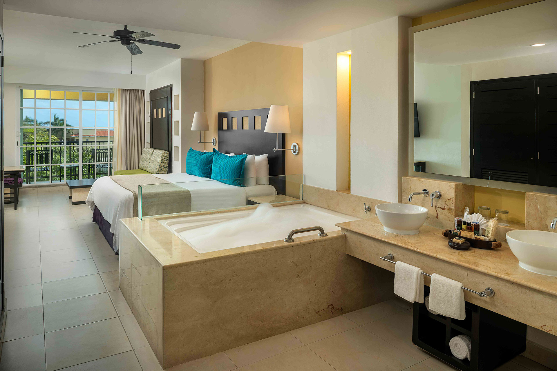 A private balcony with a a jacuzzi and seating area